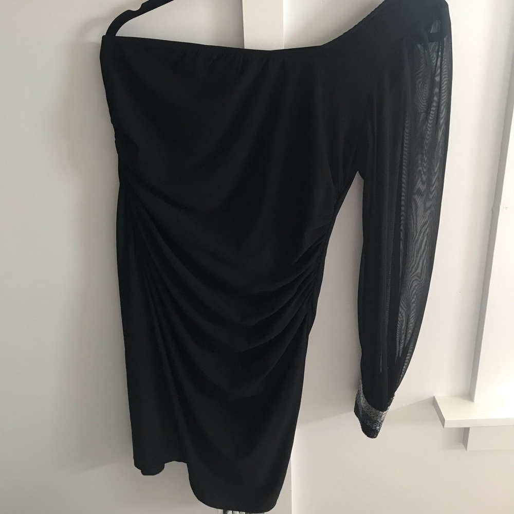 Stunning one sheer sleeved little black dress